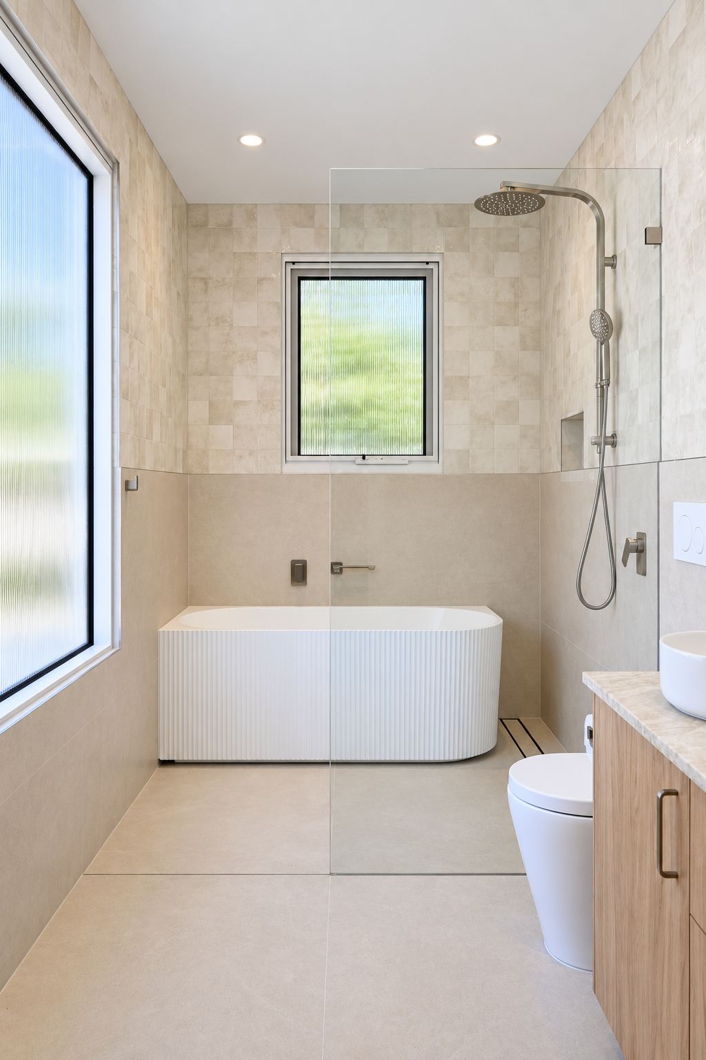 Bathroom with freestanding bath, rain shower and handmade tiles