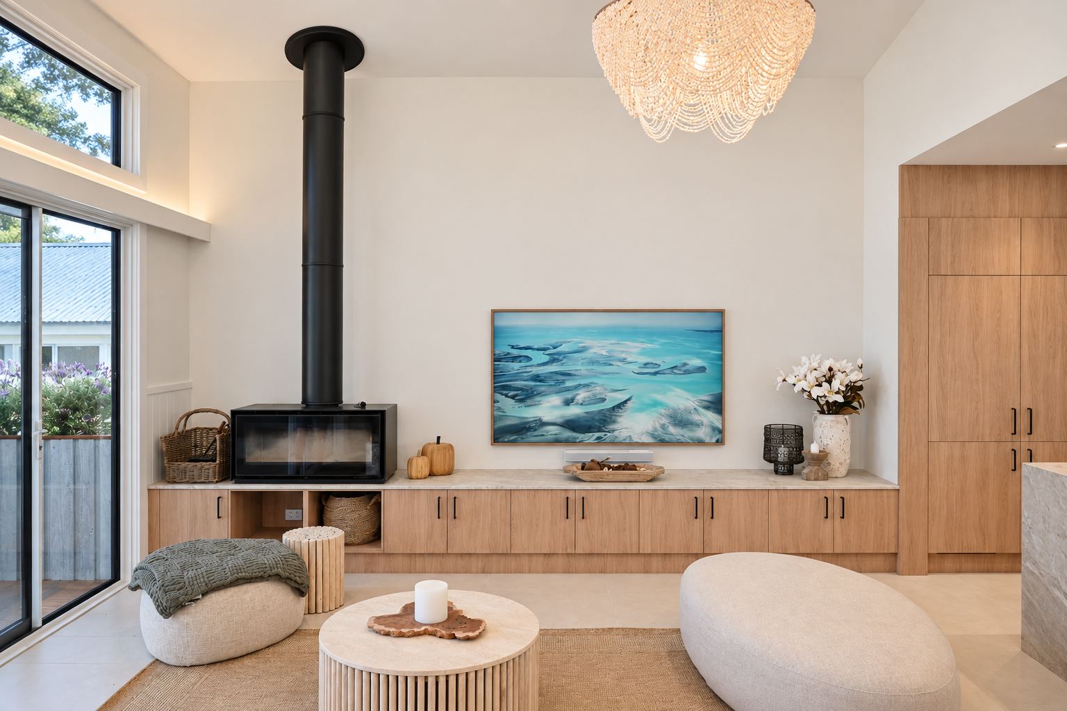 Lounge with black wood fireplace, oak media wall and curved sofa