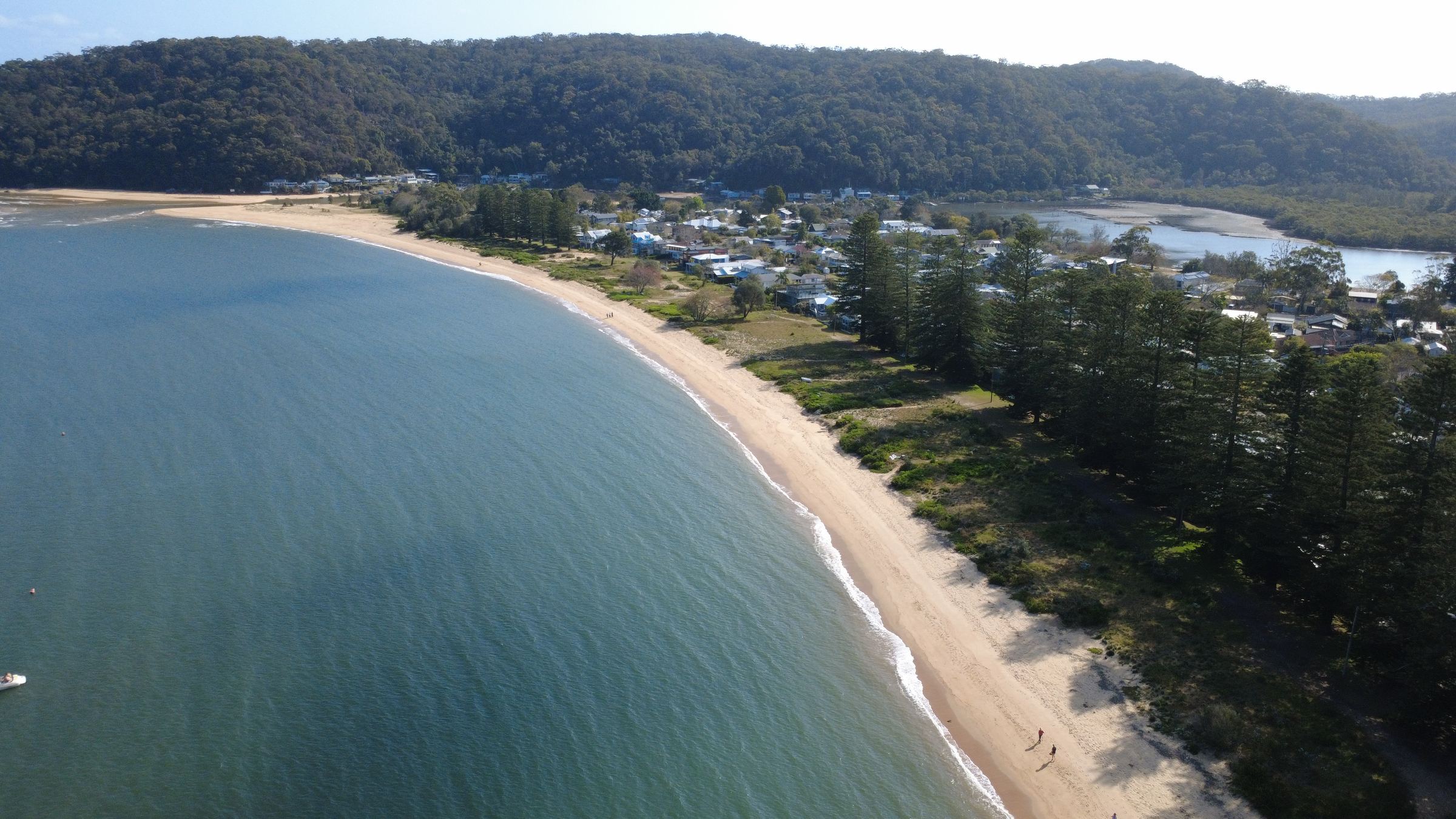 Aerial view of Patonga Beach curving along Broken Bay below the national park