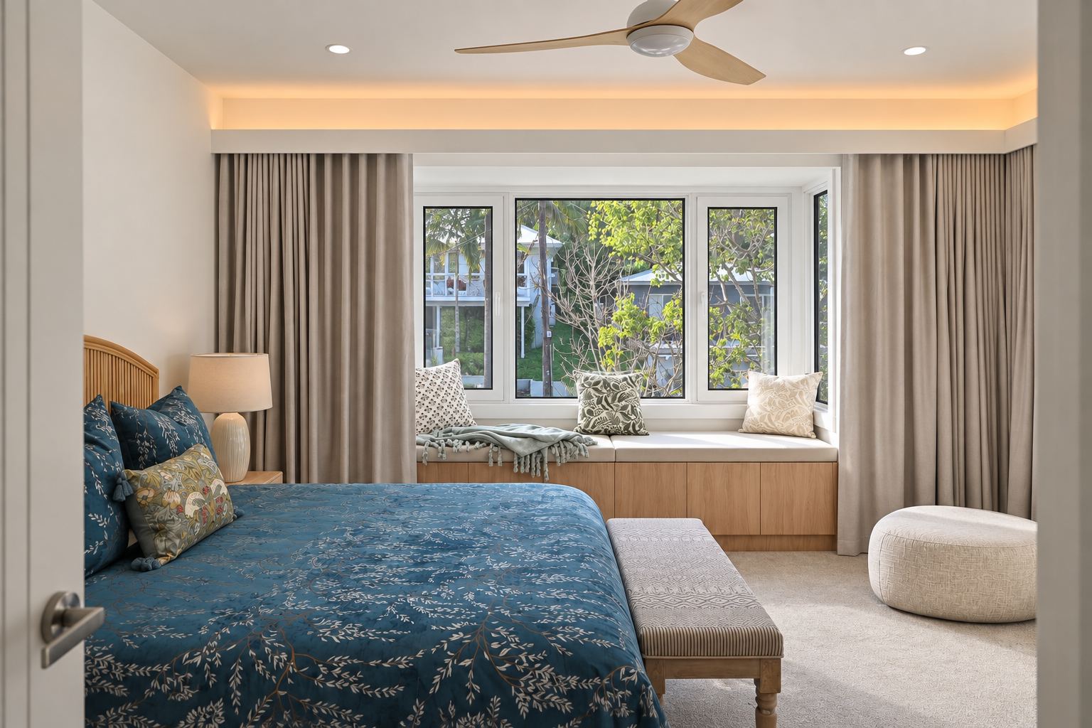King bedroom with window seat, velvet bedspread and upholstered bench