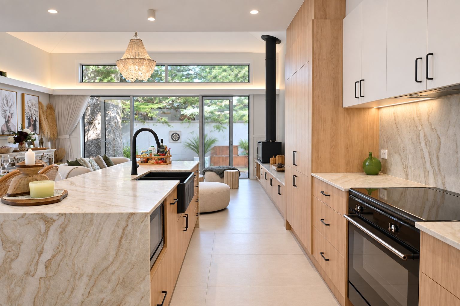 Kitchen with stone waterfall island, oak cabinetry and black tapware