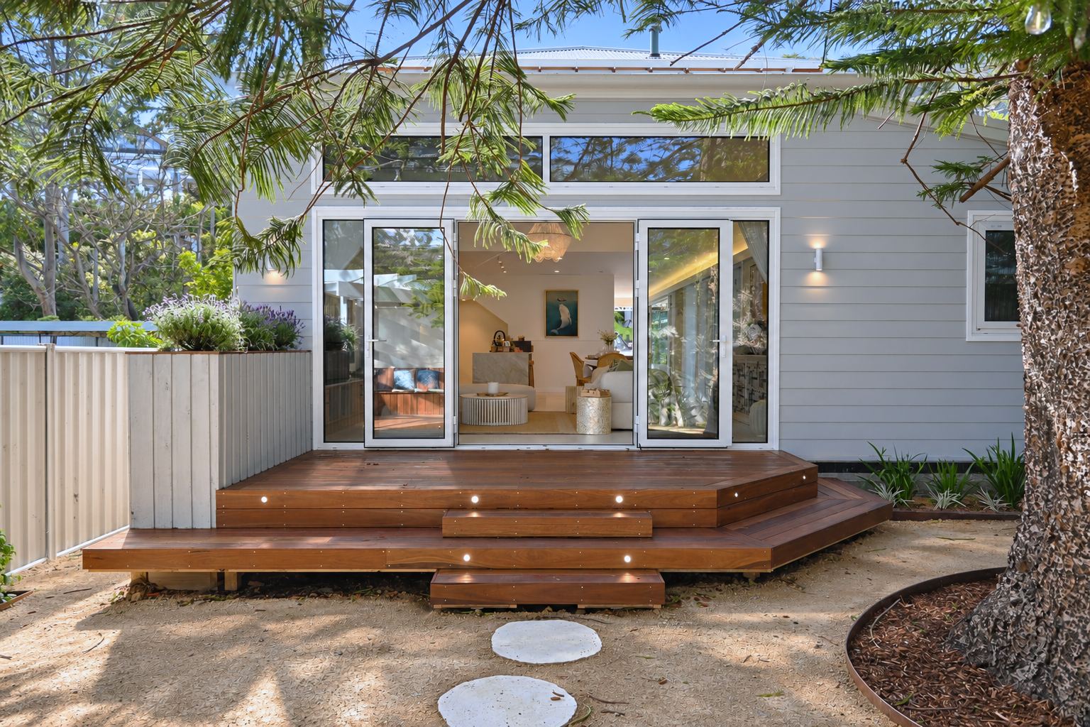 Timber deck landing with inset step lights, opening into the living room