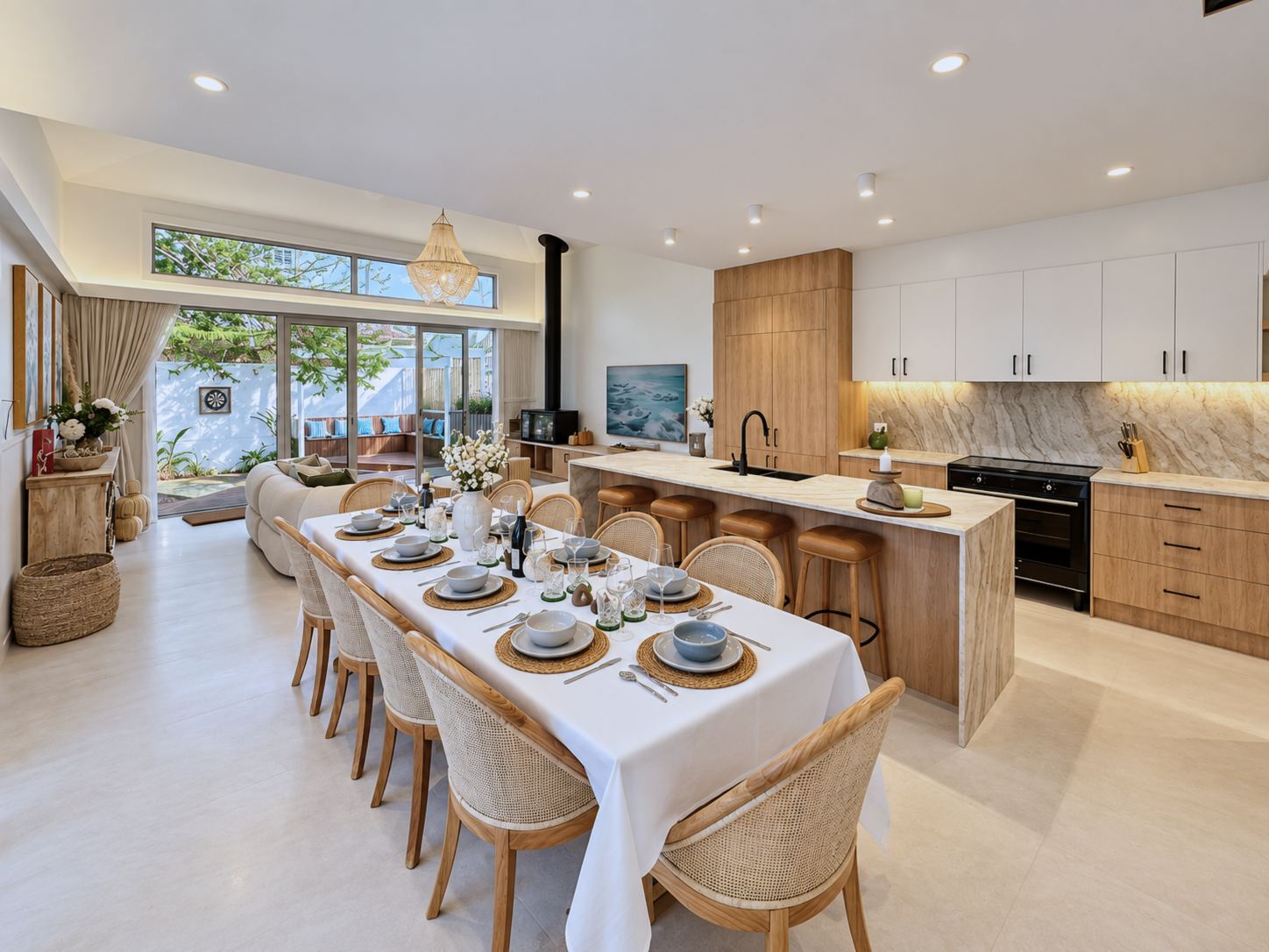 Open-plan kitchen and dining room with a long table set for twelve