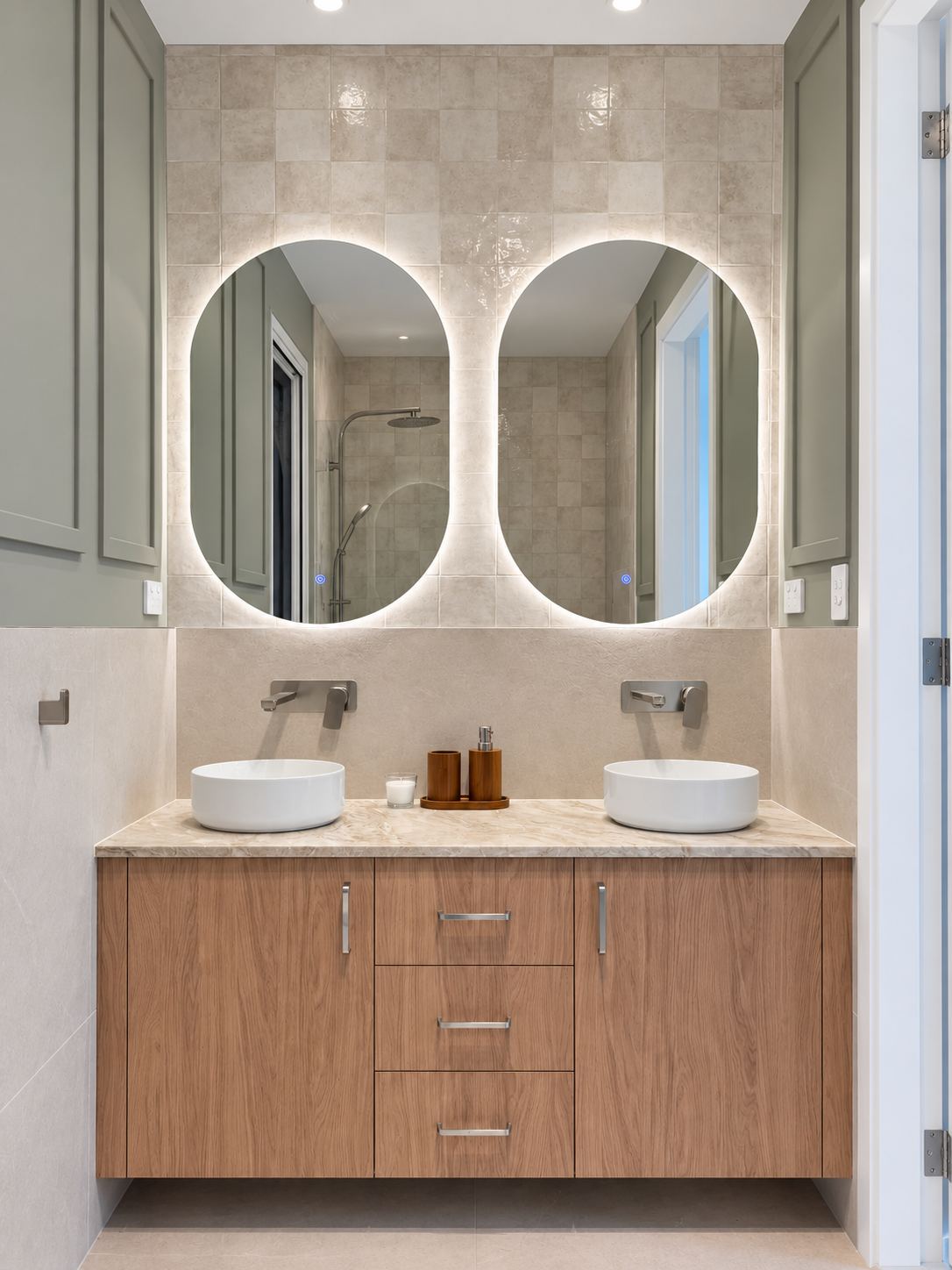 Double vanity with two backlit oval mirrors